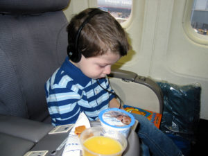 Child eating on airplane.
